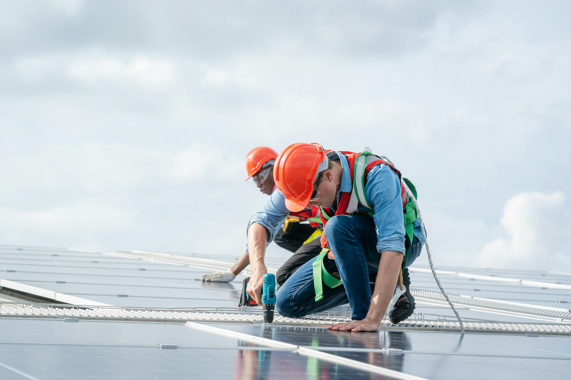 Technician inspection and repair solar cell on the roof of factory.
